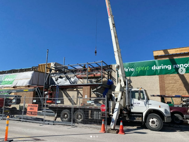 Merit Iron boom truck providing crane service at a construction site